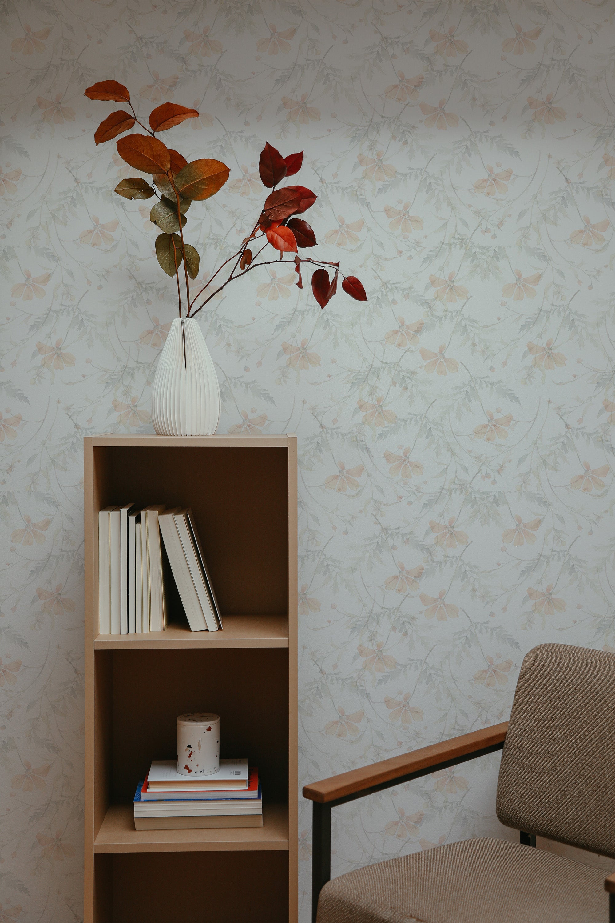 Self-adhesive wallpaper with a Subtle Floral design in a room, including a bookshelf, plant, and a section of a chair.