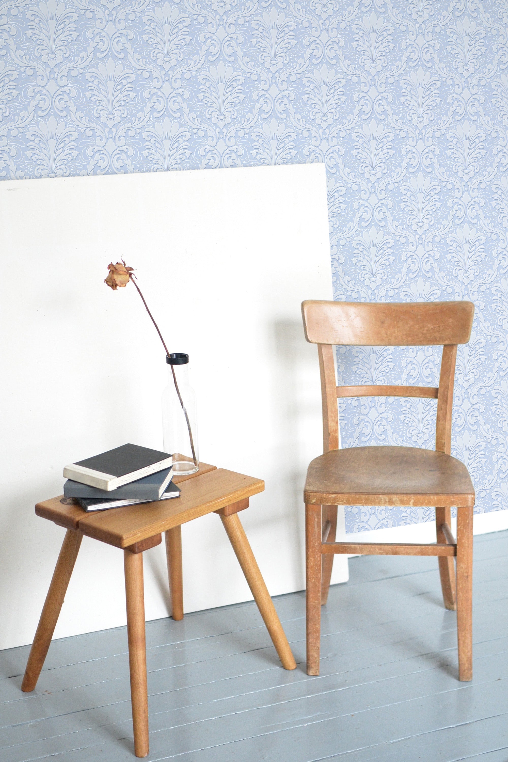Self-adhesive wallpaper in light blue damask pattern with intricate floral and scroll motifs, offering a classic and elegant touch to the room.