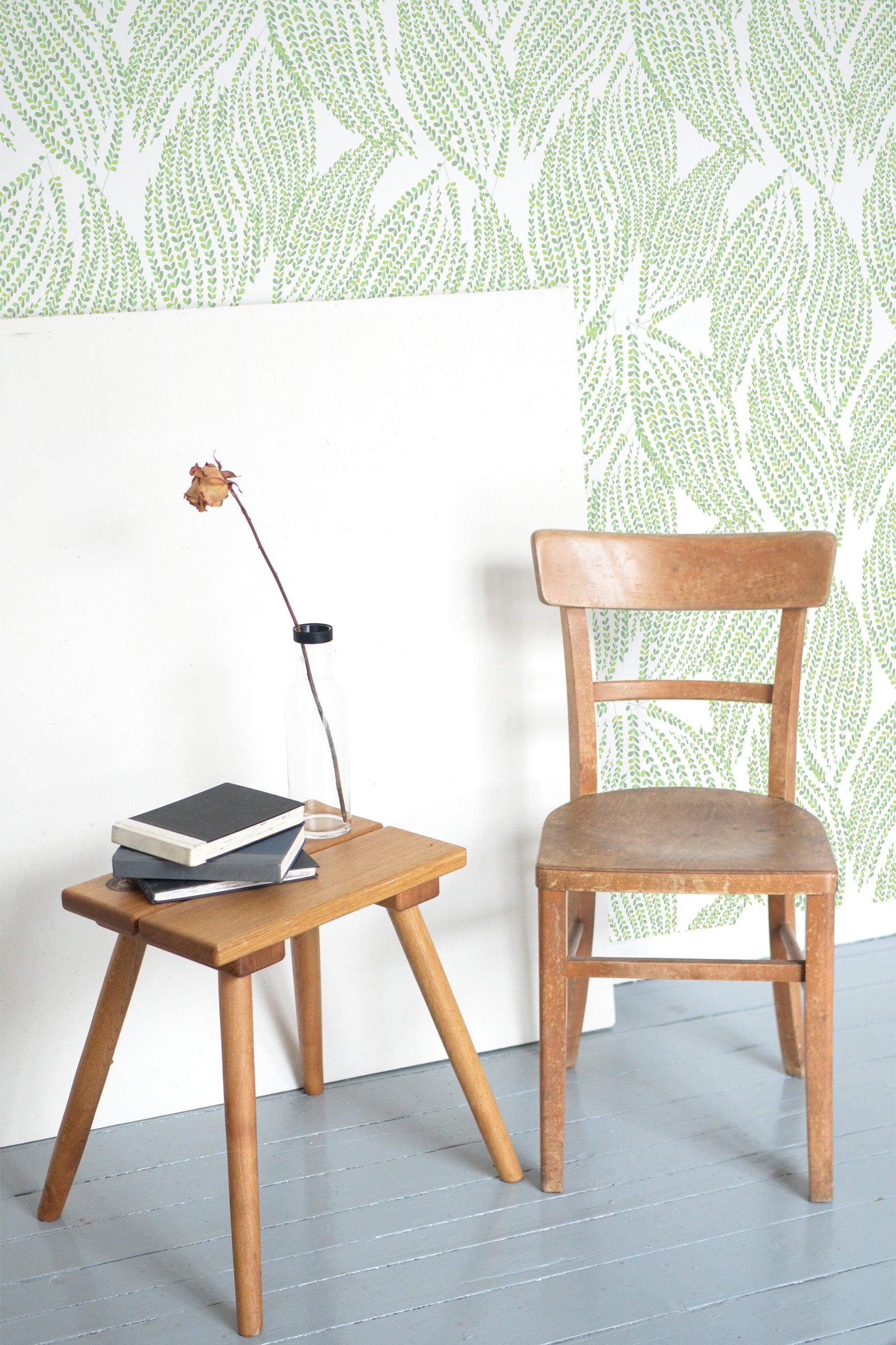 Self-adhesive wallpaper with an intricate, leafy pattern in light green tones on a white background, creating a fresh and natural look.