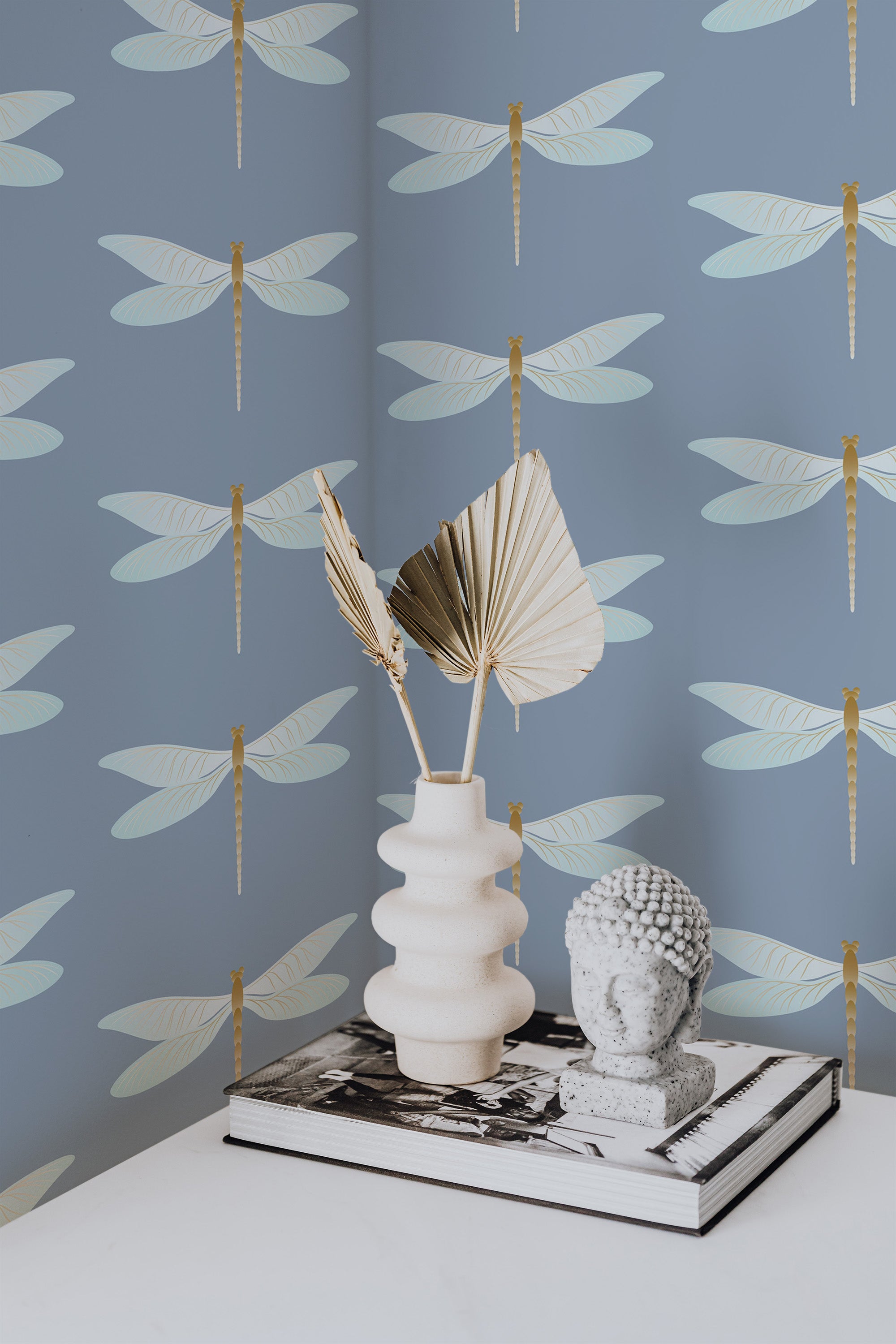 Self-adhesive wallpaper adorned with elegant gold and pale cream dragonflies over a soft blue background, adding a serene and stylish touch to the room.