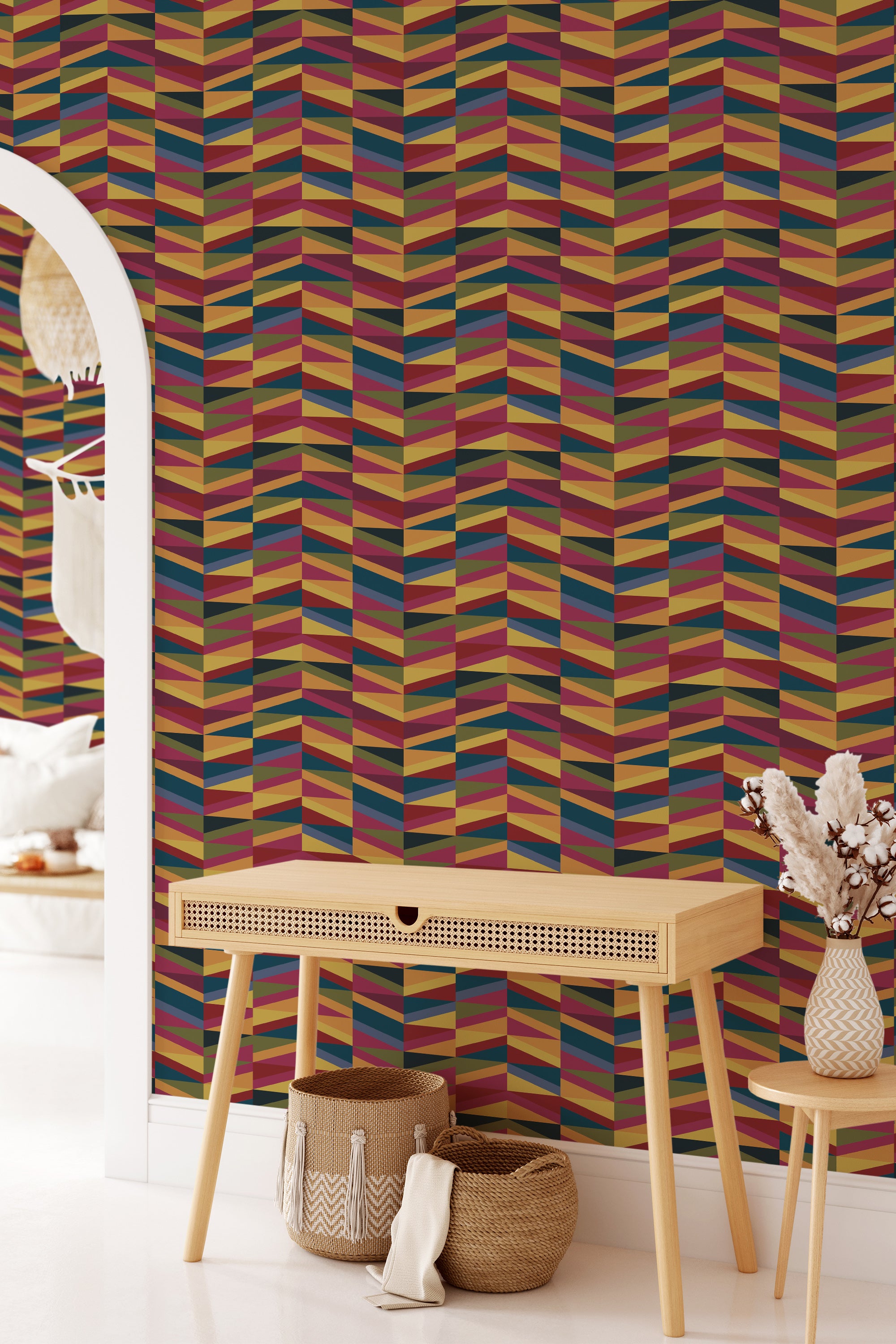 A room with bold triangle-patterned wallpaper in a multicolored design with red, yellow, blue, and brown hues on a wall, paired with modern furniture, embodying a traditional wallpaper style.
