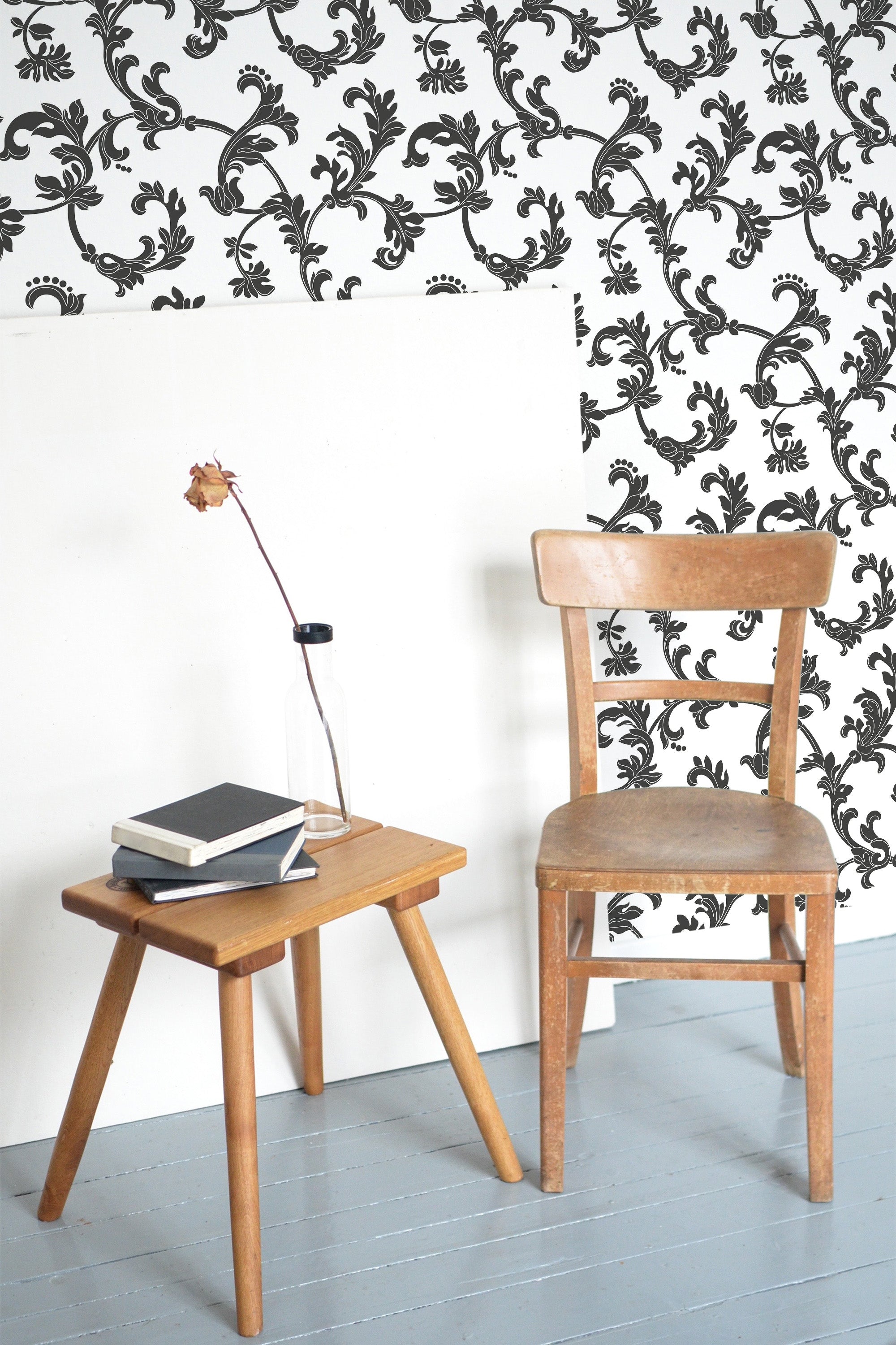 Self-adhesive wallpaper with intricate black vintage ornamental patterns on a white background, creating a classic and elegant atmosphere in the room.