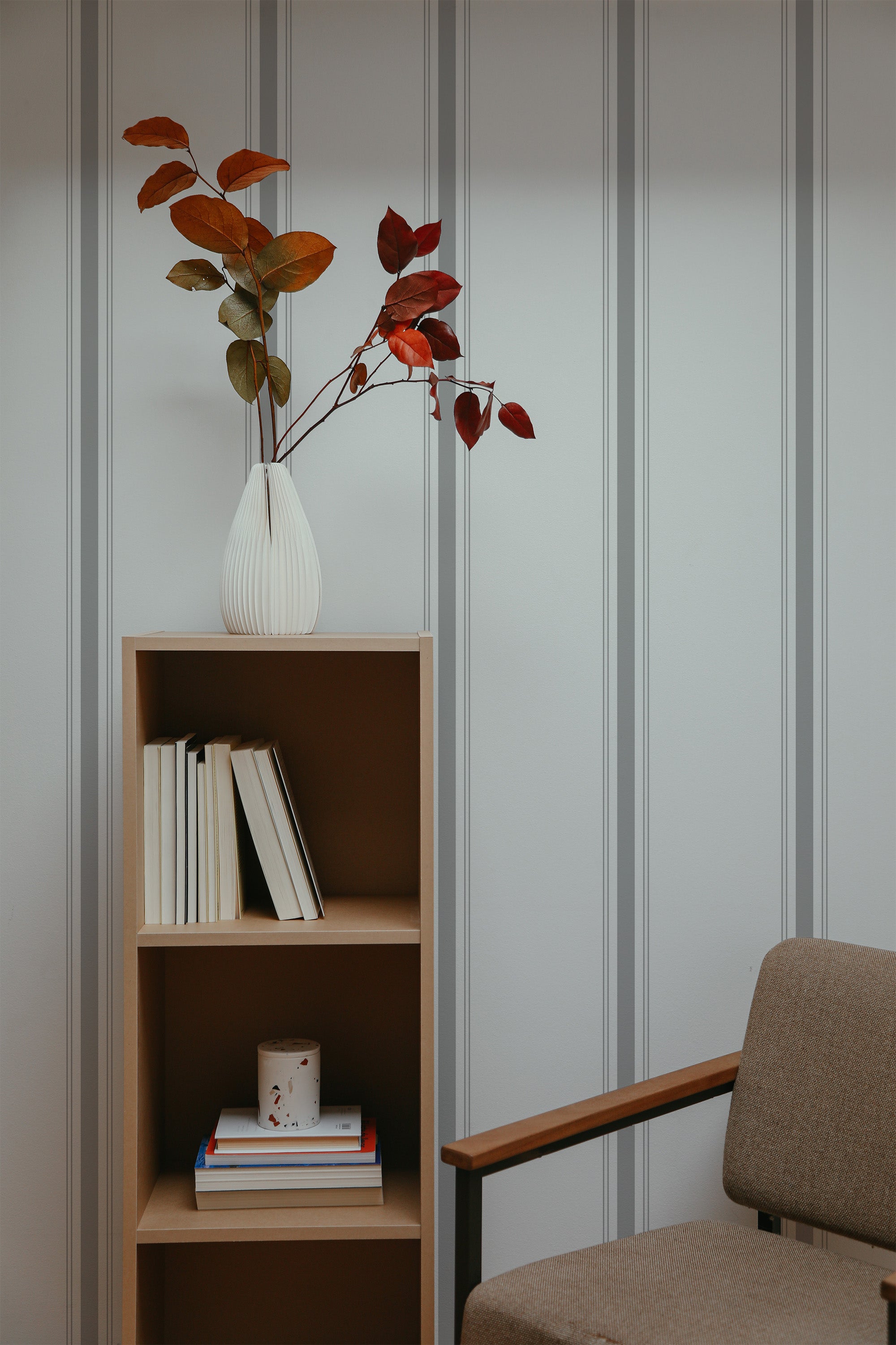 Self-adhesive vertical line wallpaper with alternating thin and thick grey stripes on a light background.