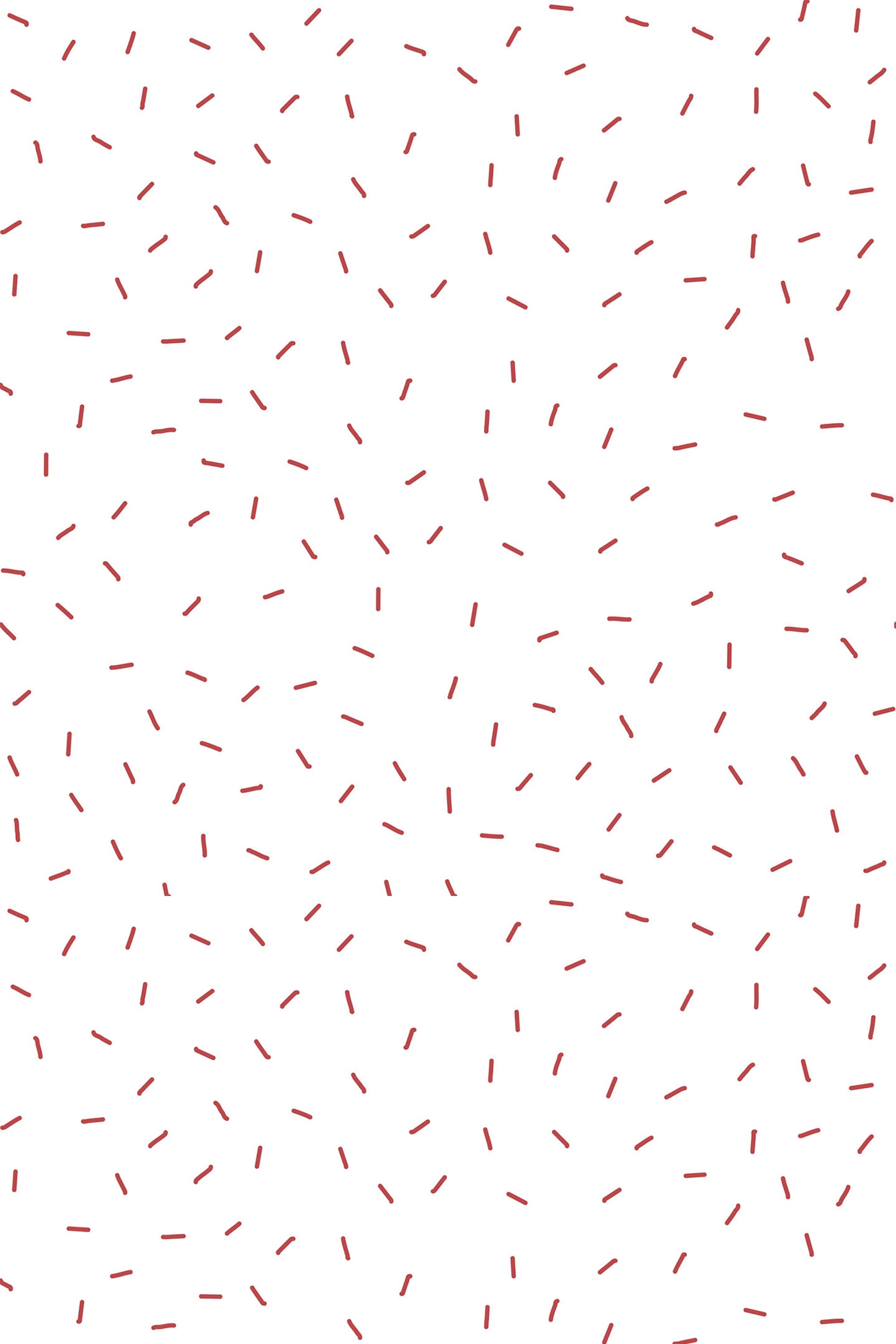 White wallpaper with a scattered pattern of small, curved red dashes resembling sprinkles, creating a playful and minimalist design. Peel and stick removable wallpaper.