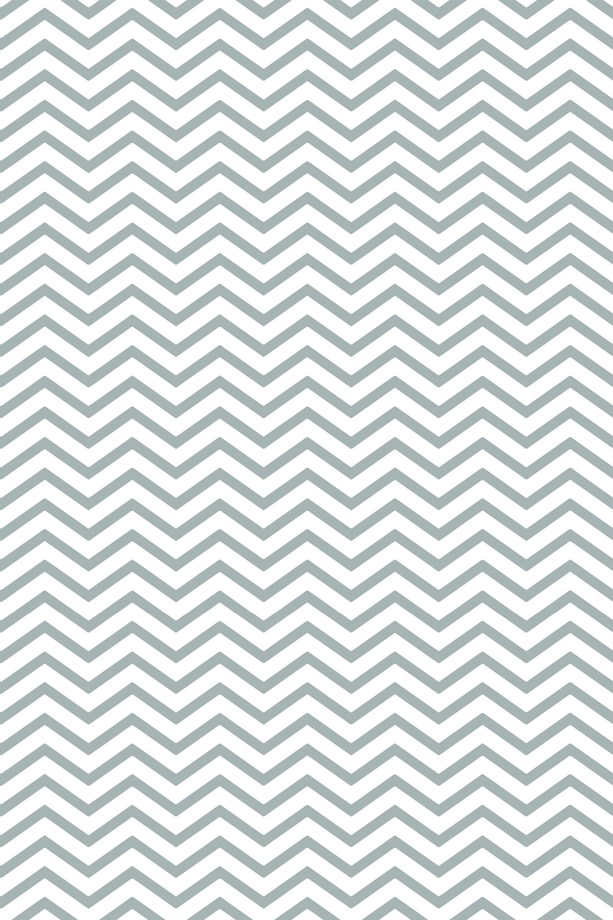 A repeating geometric pattern with zigzagging lines creates a chevron design in a soft gray color on a white background. Peel and stick removable wallpaper.