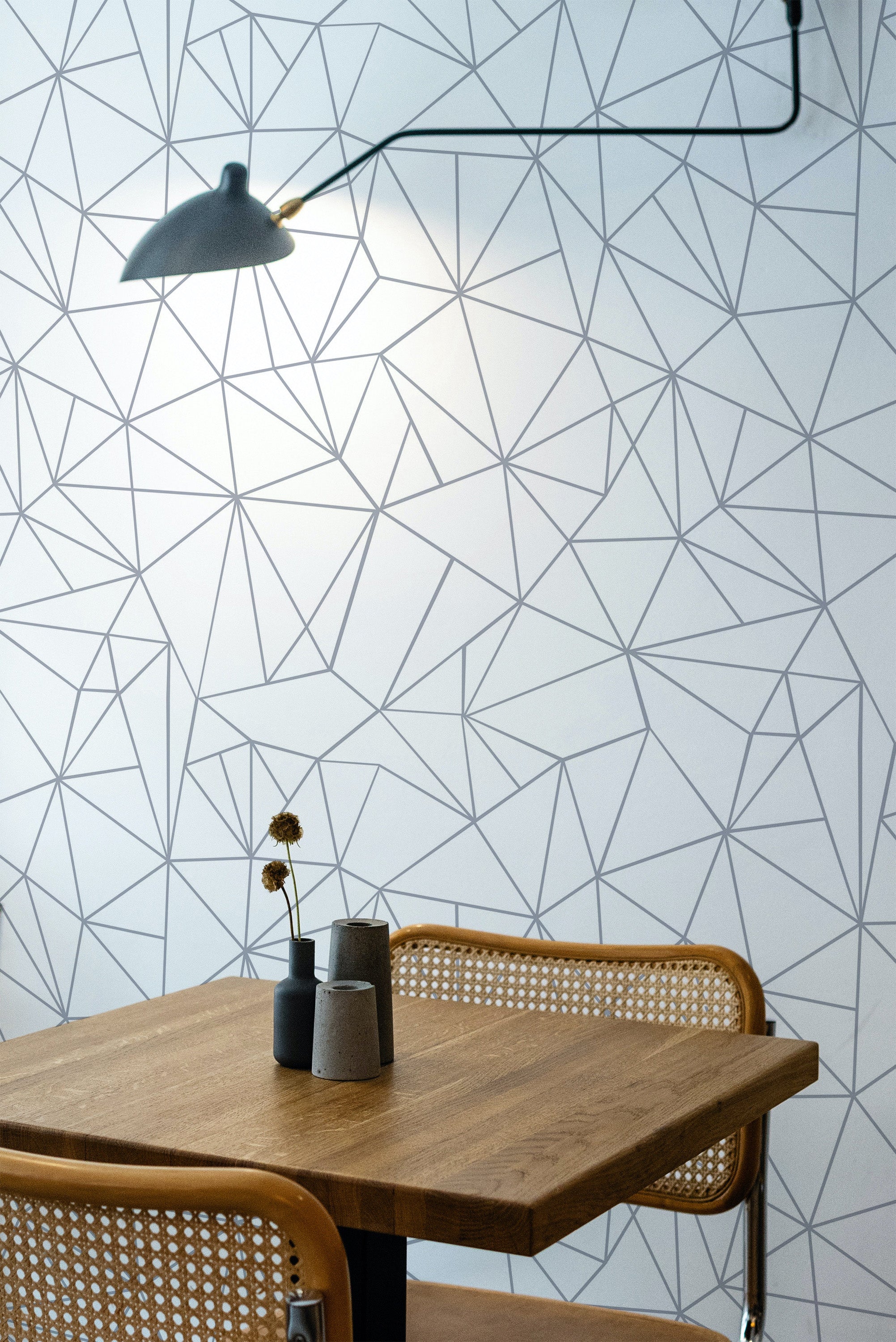 Self-adhesive wallpaper with a modern mosaic design, featuring an intricate pattern of intersecting geometric lines in black on a white background.