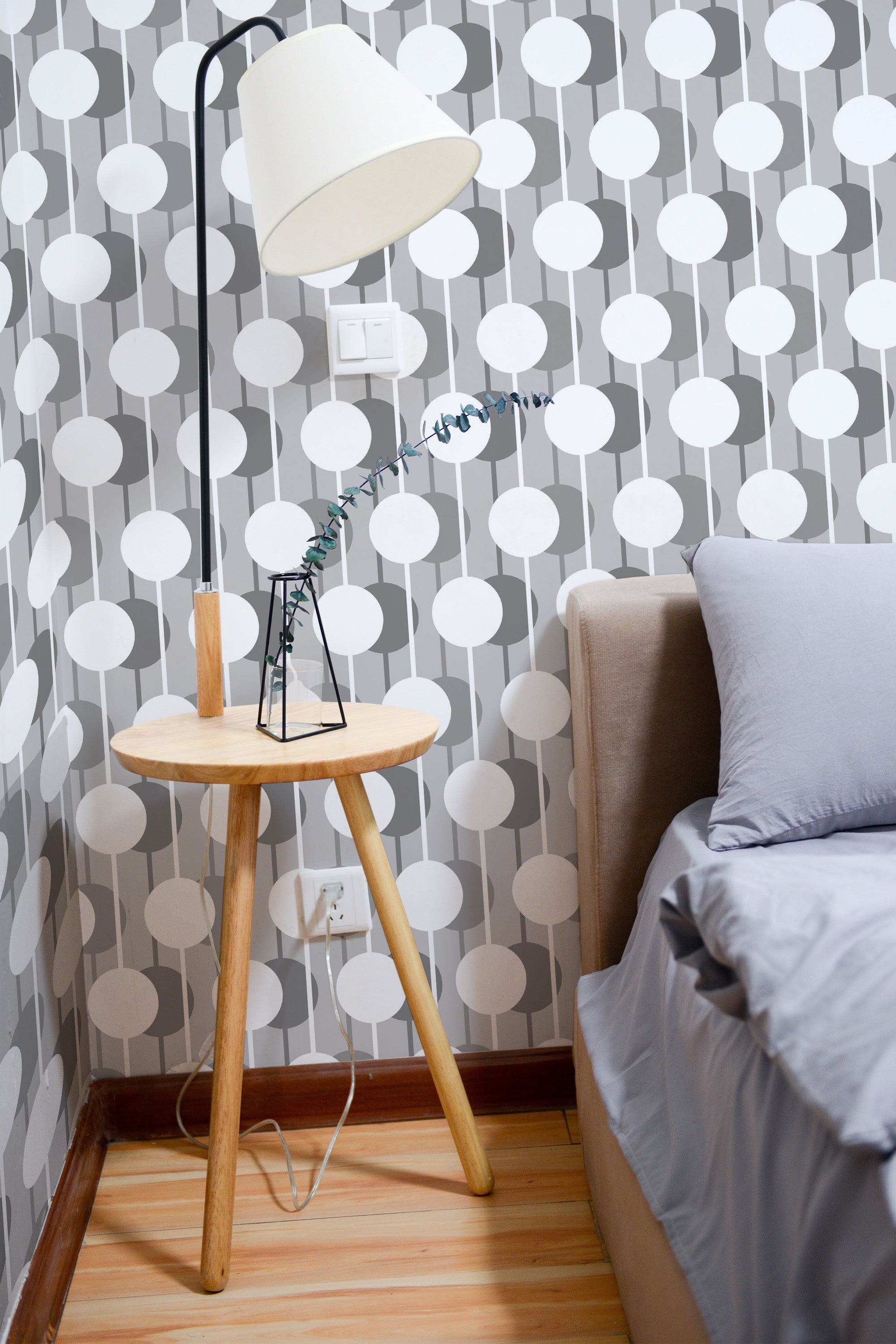 Self-adhesive wallpaper with a 3D circle design in white and shades of gray, creating a geometric pattern that adds depth and modernity to the room's decor.