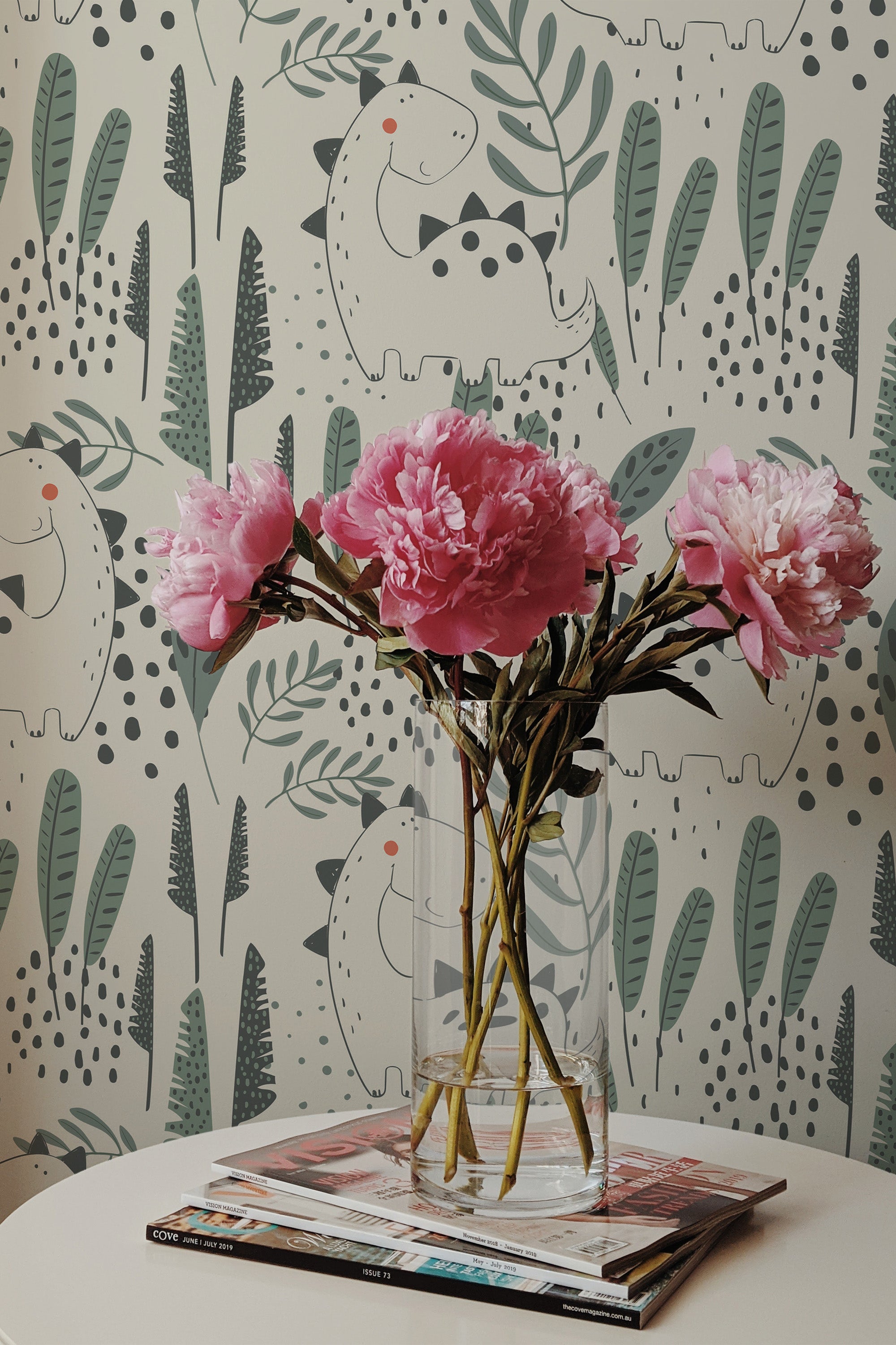 Self-adhesive wallpaper with playful dinosaur illustrations amidst foliage on a neutral background.