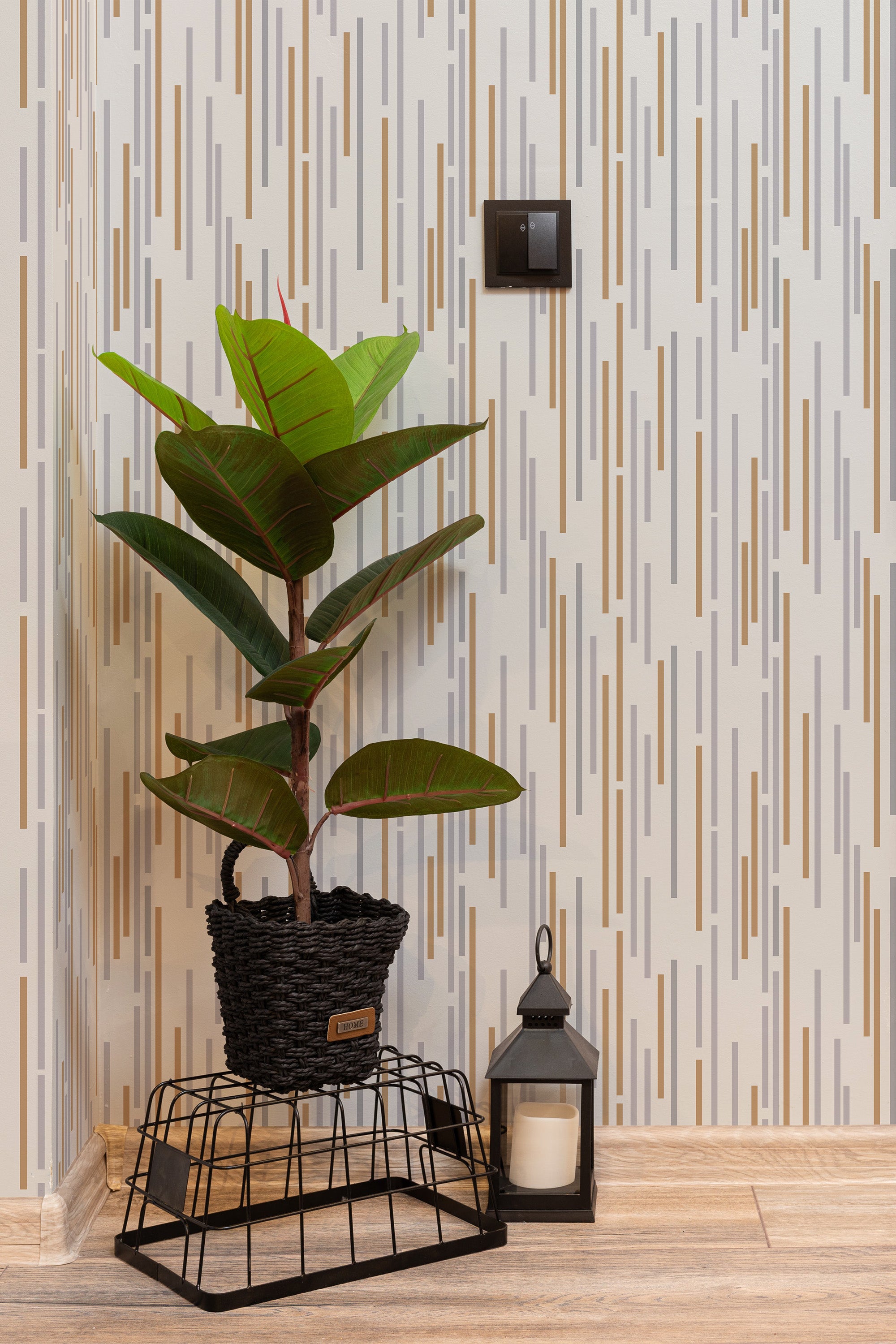 Self-adhesive wallpaper with a neutral stripe pattern of vertical lines in varying shades of beige, gray, and brown against a light background.