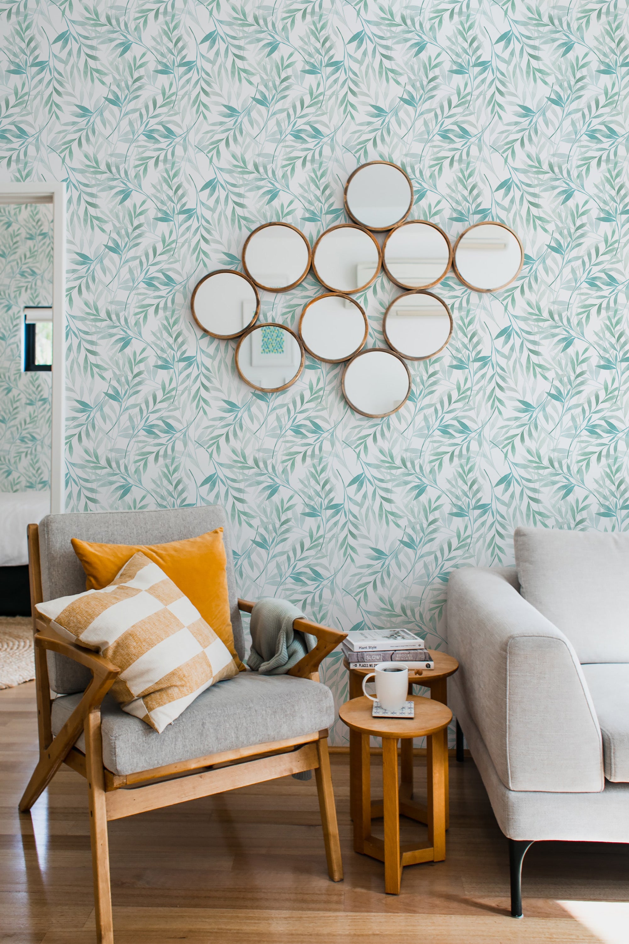 The wallpaper design shows delicate green watercolor leaves scattered across a soft white background, creating an organic, airy feel. Traditional wallpaper.