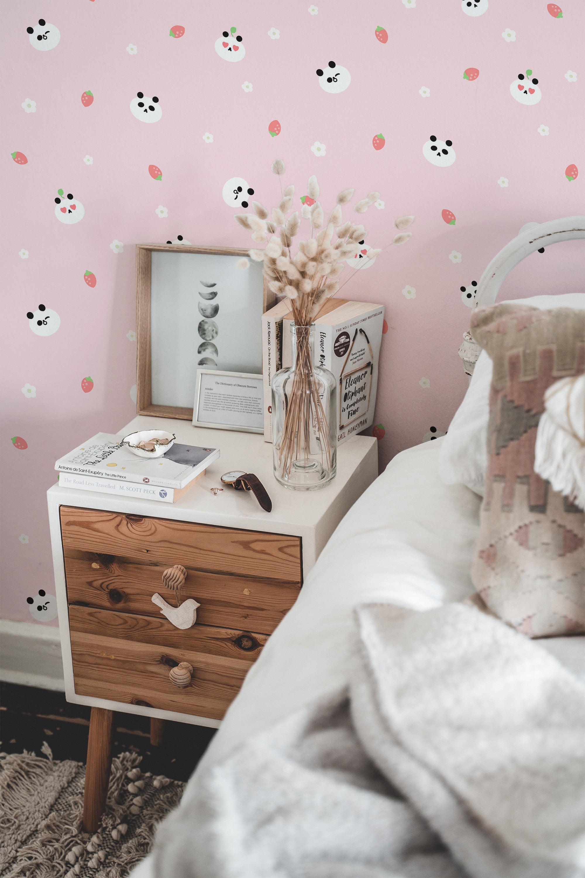 Self-adhesive Kawaii wallpaper with cute panda faces, strawberries, and small white flowers on a soft pink background adds a playful and cheerful touch to the room.