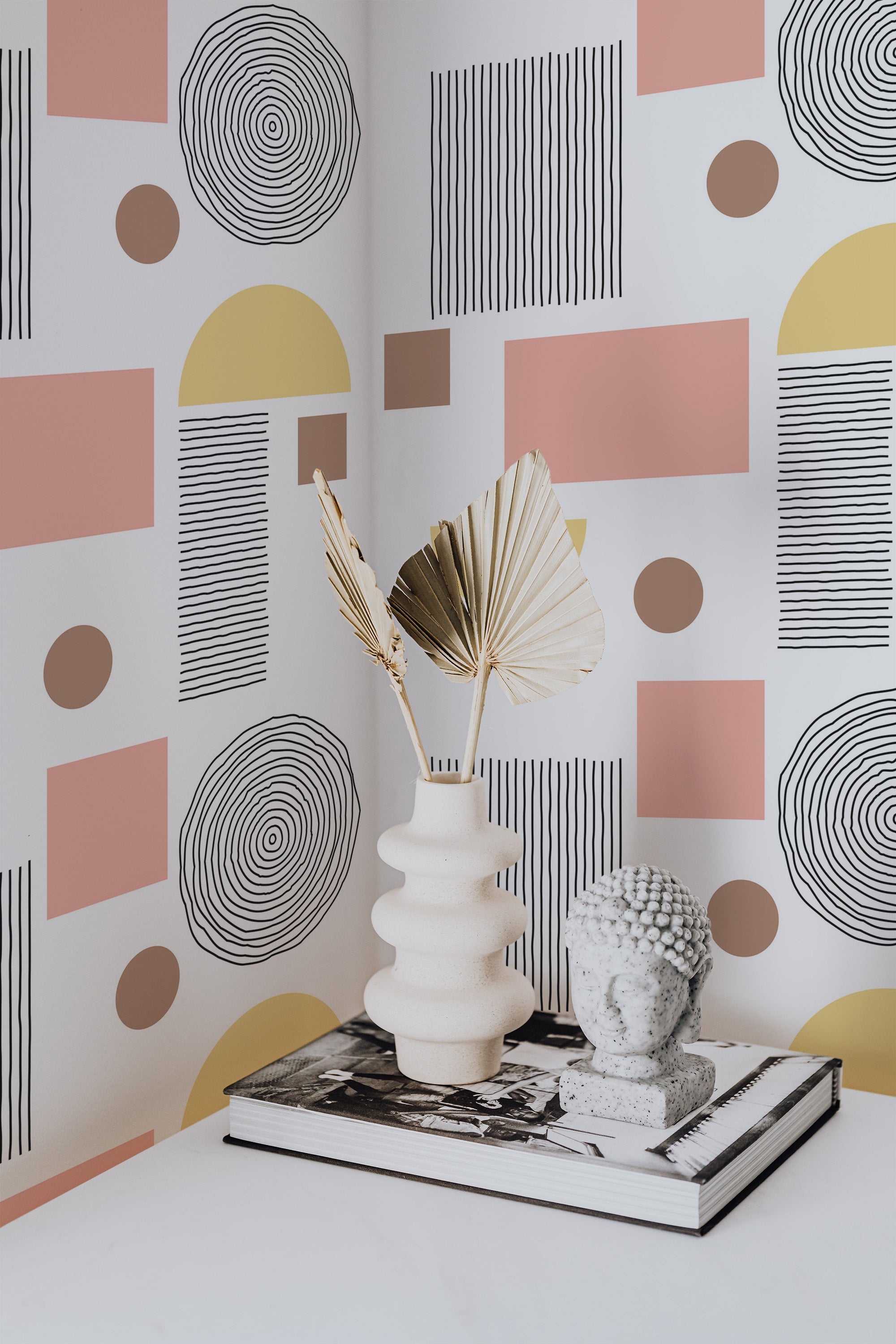 Self-adhesive wallpaper with a Boho circle design, incorporating abstract shapes like concentric circles, rectangles, and semicircles in muted tones of pink, yellow, and brown against a white background.