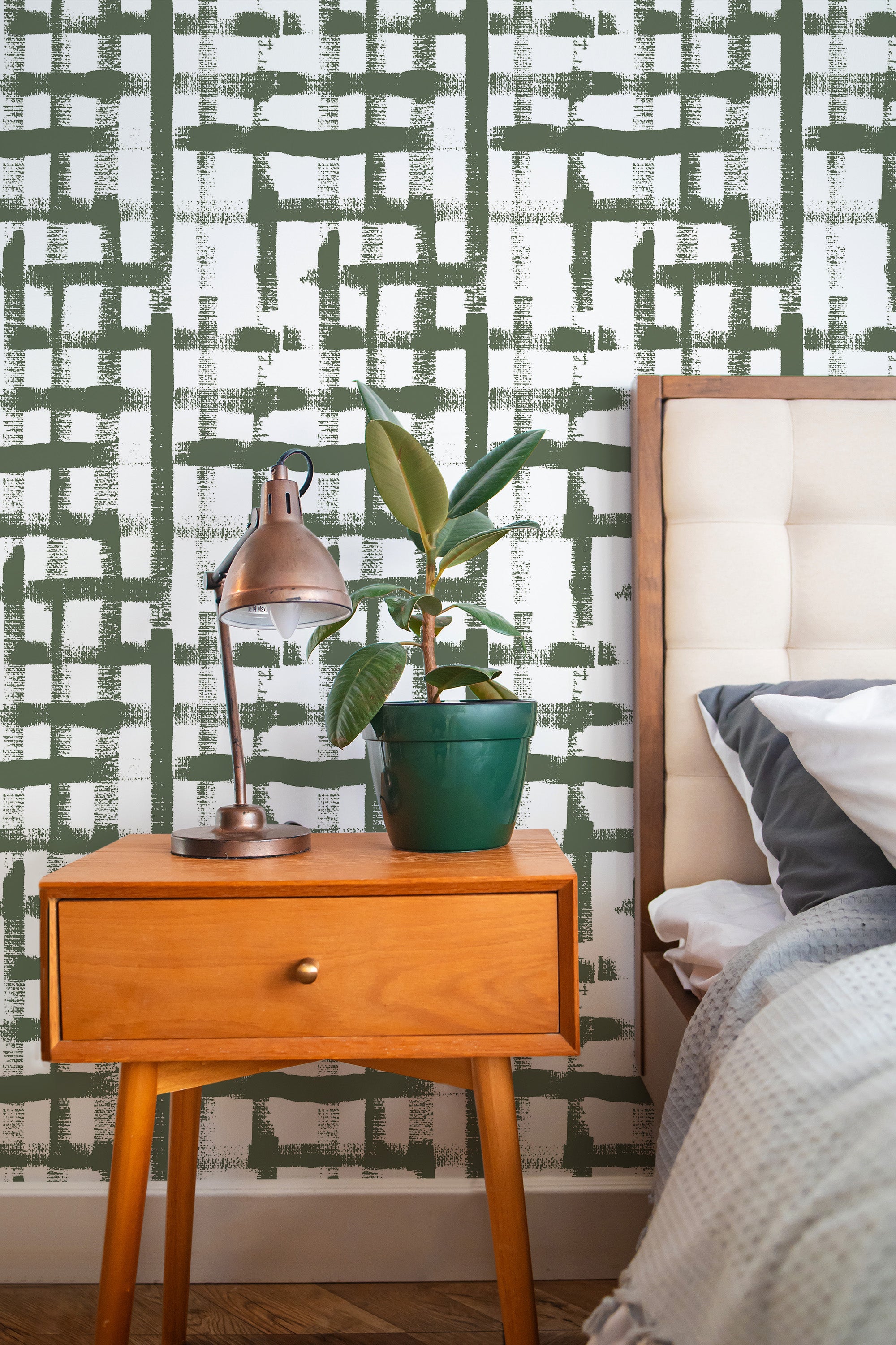 Self-adhesive wallpaper with a Brush stroke grid design in green, with overlapping strokes creating an abstract, modern pattern on a white background.