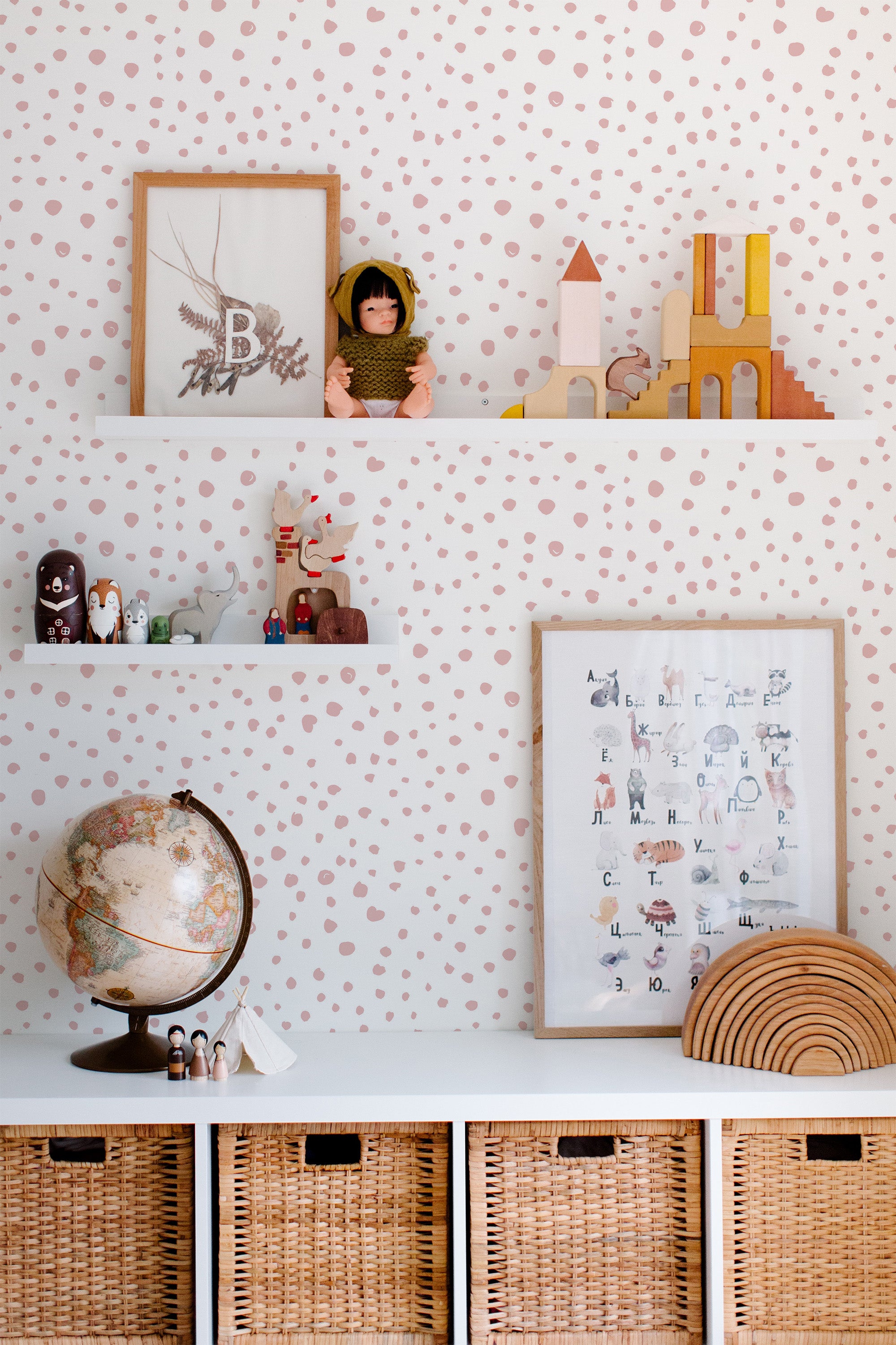 Self-adhesive wallpaper with a dotted print design in soft pink, creating a playful and charming backdrop in the room.