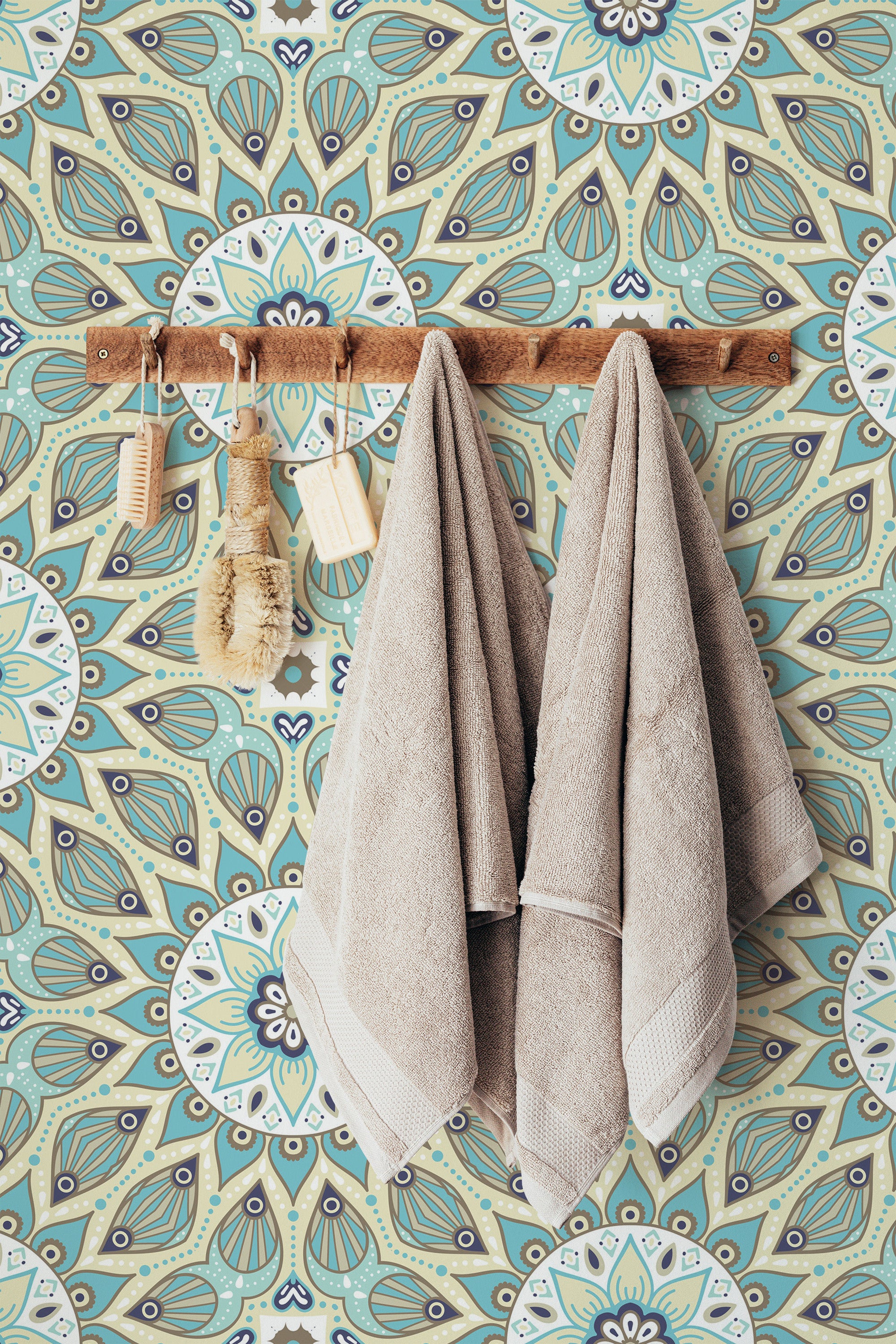 Self-adhesive wallpaper with a Mandala design featuring intricate circular patterns in shades of blue, green, and beige, creating a soothing and symmetrical background for the rustic wooden towel rack and neutral-colored towels hung on the wall.