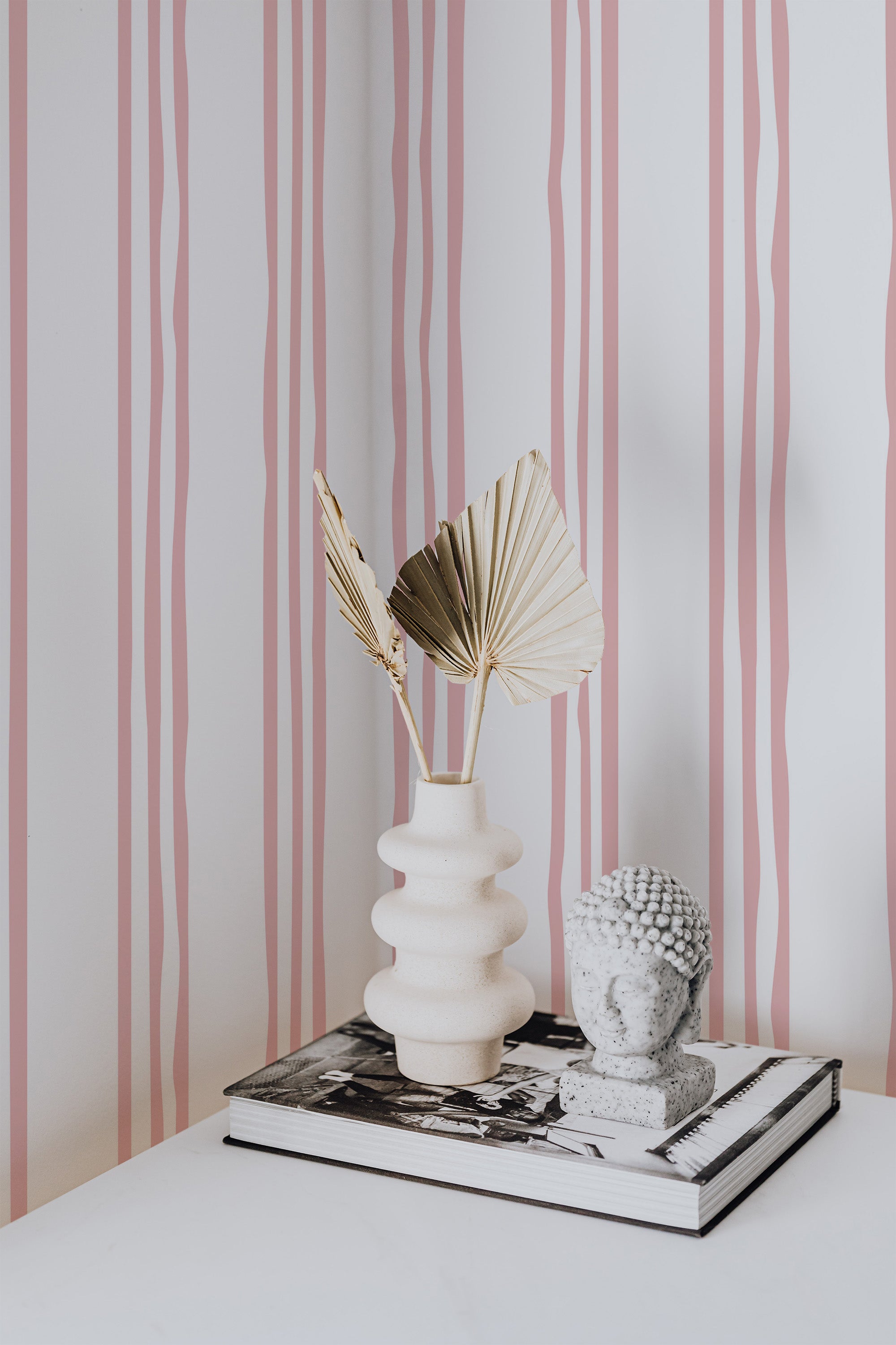Self-adhesive wallpaper with a striped design, combining vertical pink stripes of varying widths against a white background, creating a modern and minimalistic aesthetic.