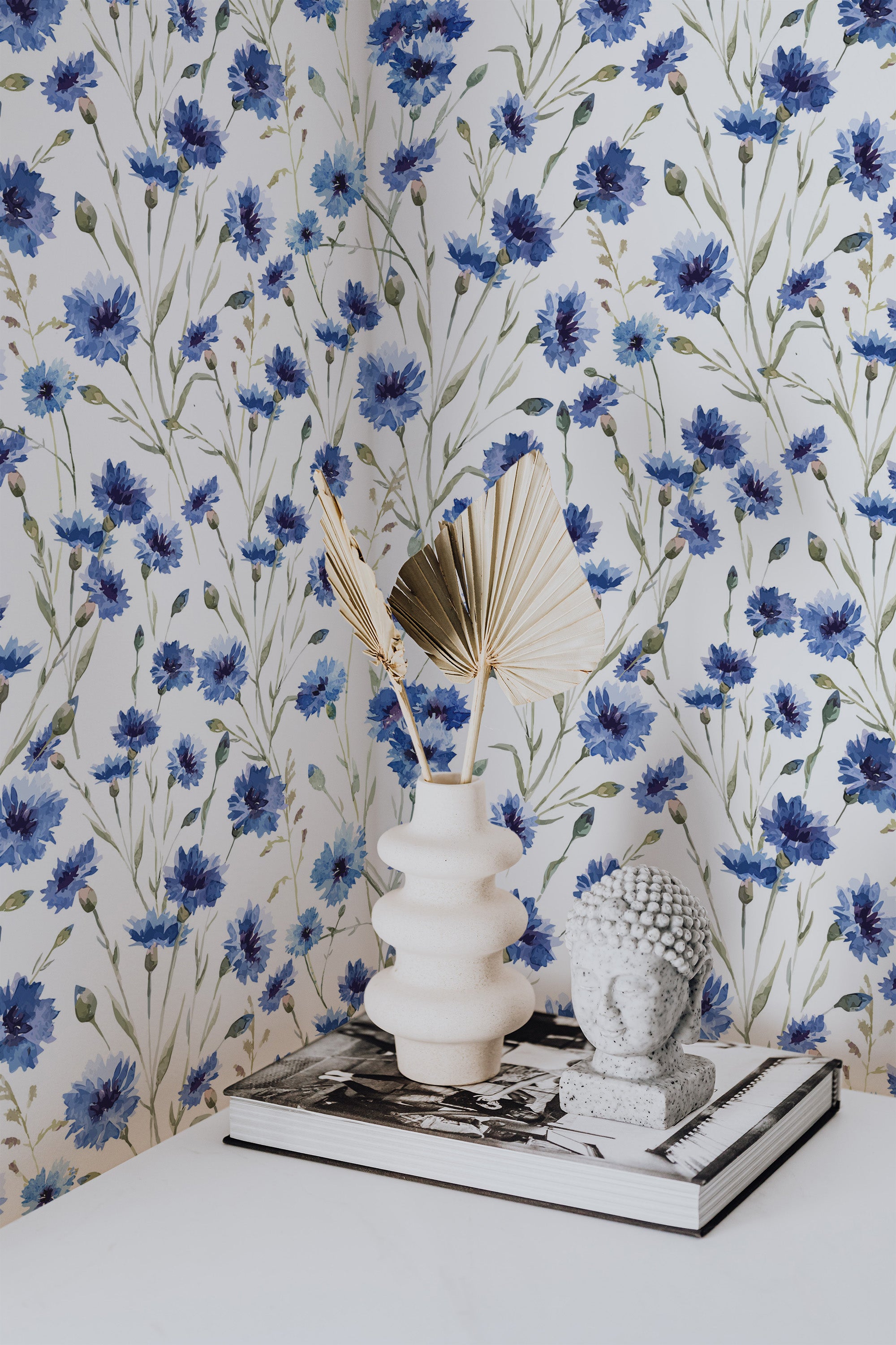 Self-adhesive blue floral print wallpaper with delicate blue flowers and green leaves on a white background, enhancing the room's tranquil and stylish ambiance.