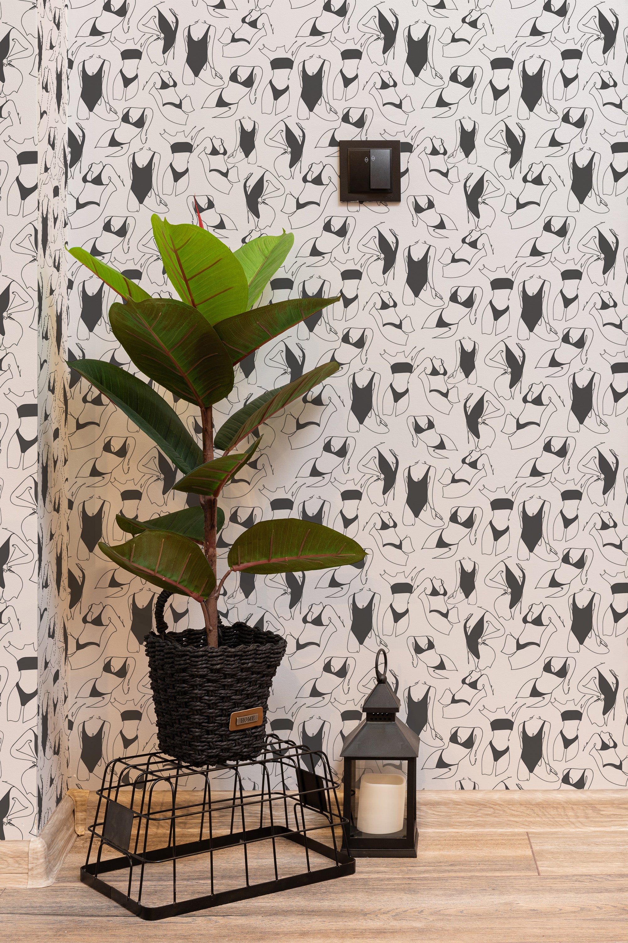 Self-adhesive wallpaper with an abstract design of minimalist female body outlines in black on a white background.