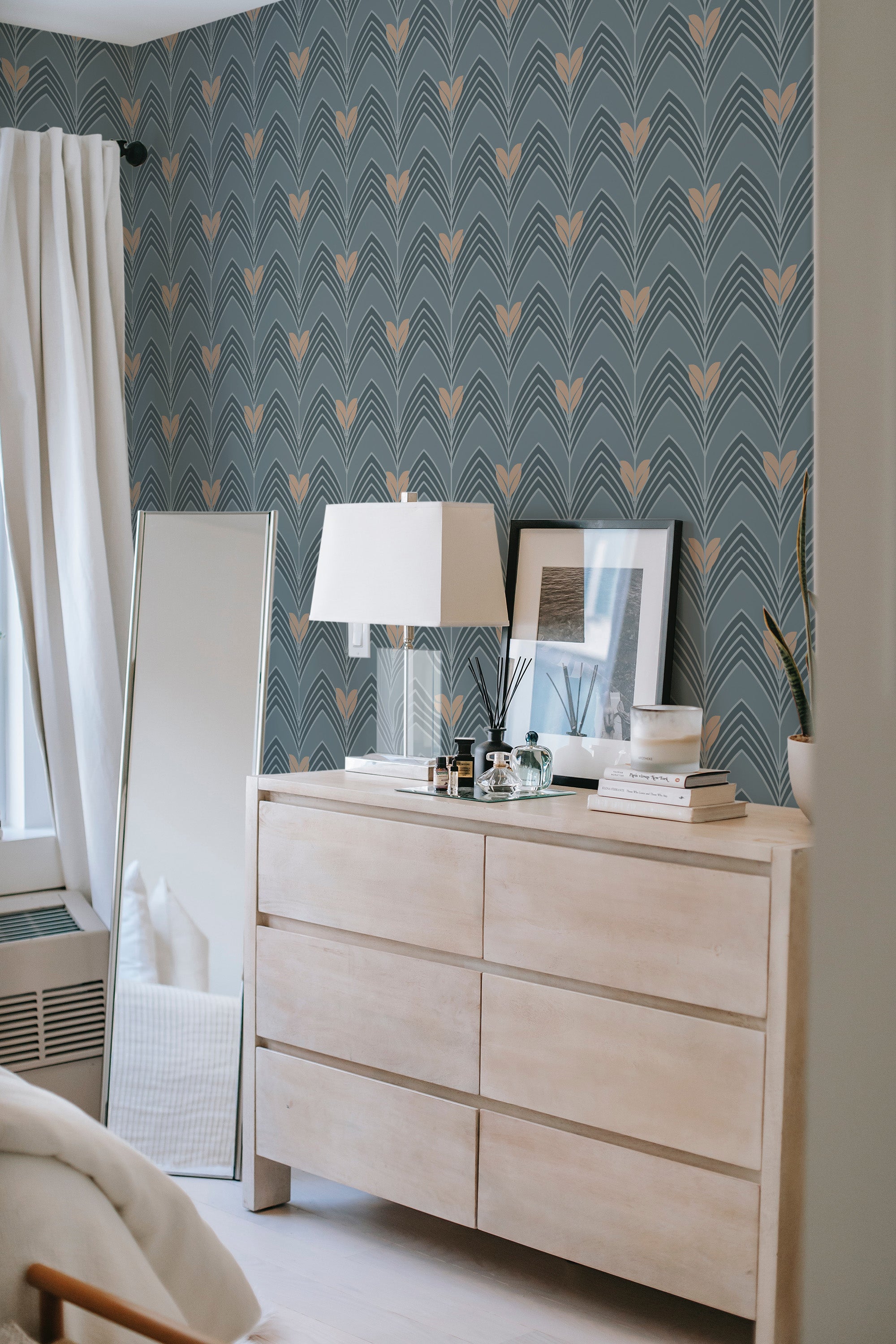 Art Deco wallpaper with a repeating pattern of geometric shapes in gold and blue tones, creating a luxurious, sophisticated feel in the room. Traditional wallpaper.