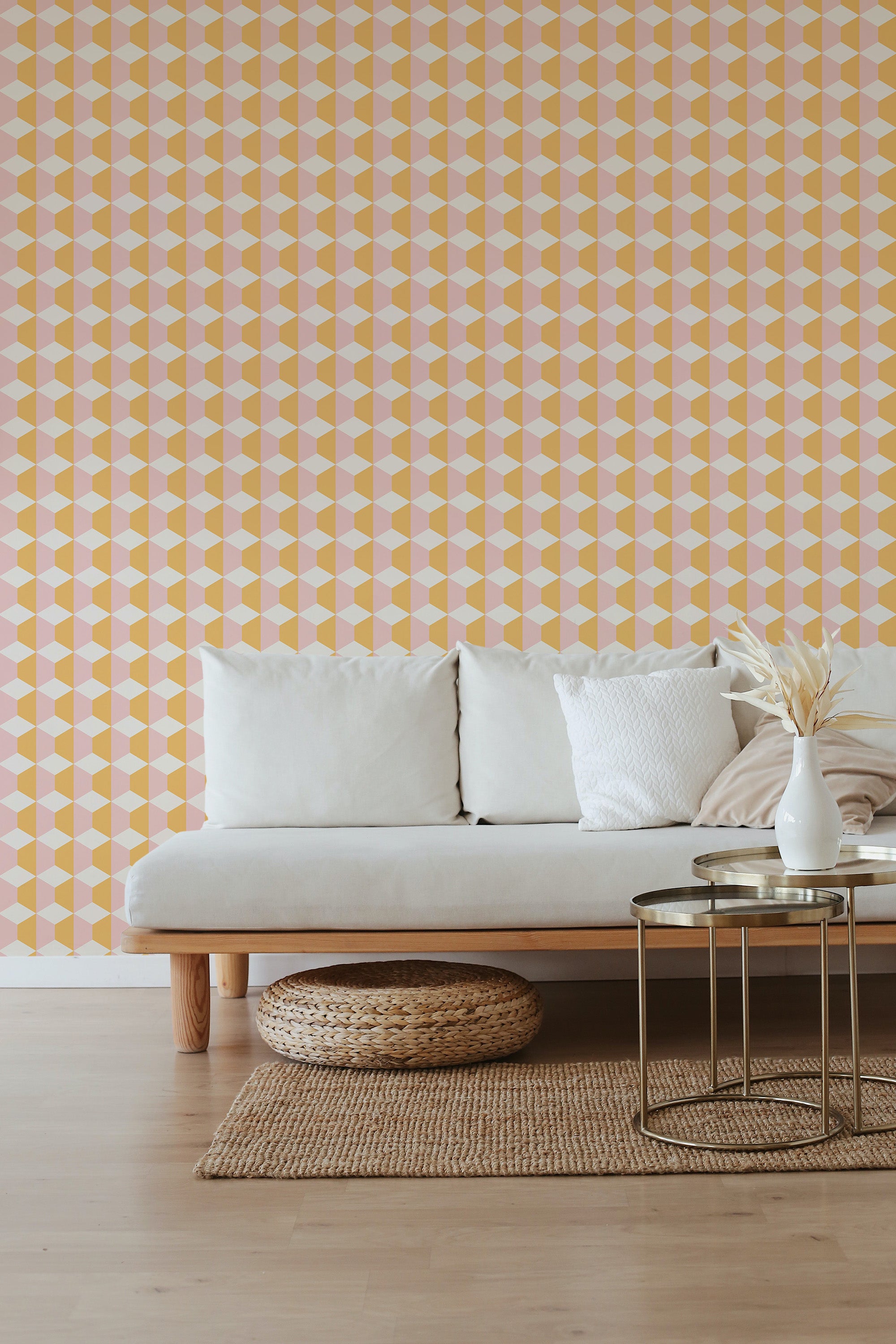 A room with pink and yellow geometric patterned wallpaper with triangles and diamonds, complementing light-toned furniture. Traditional wallpaper.