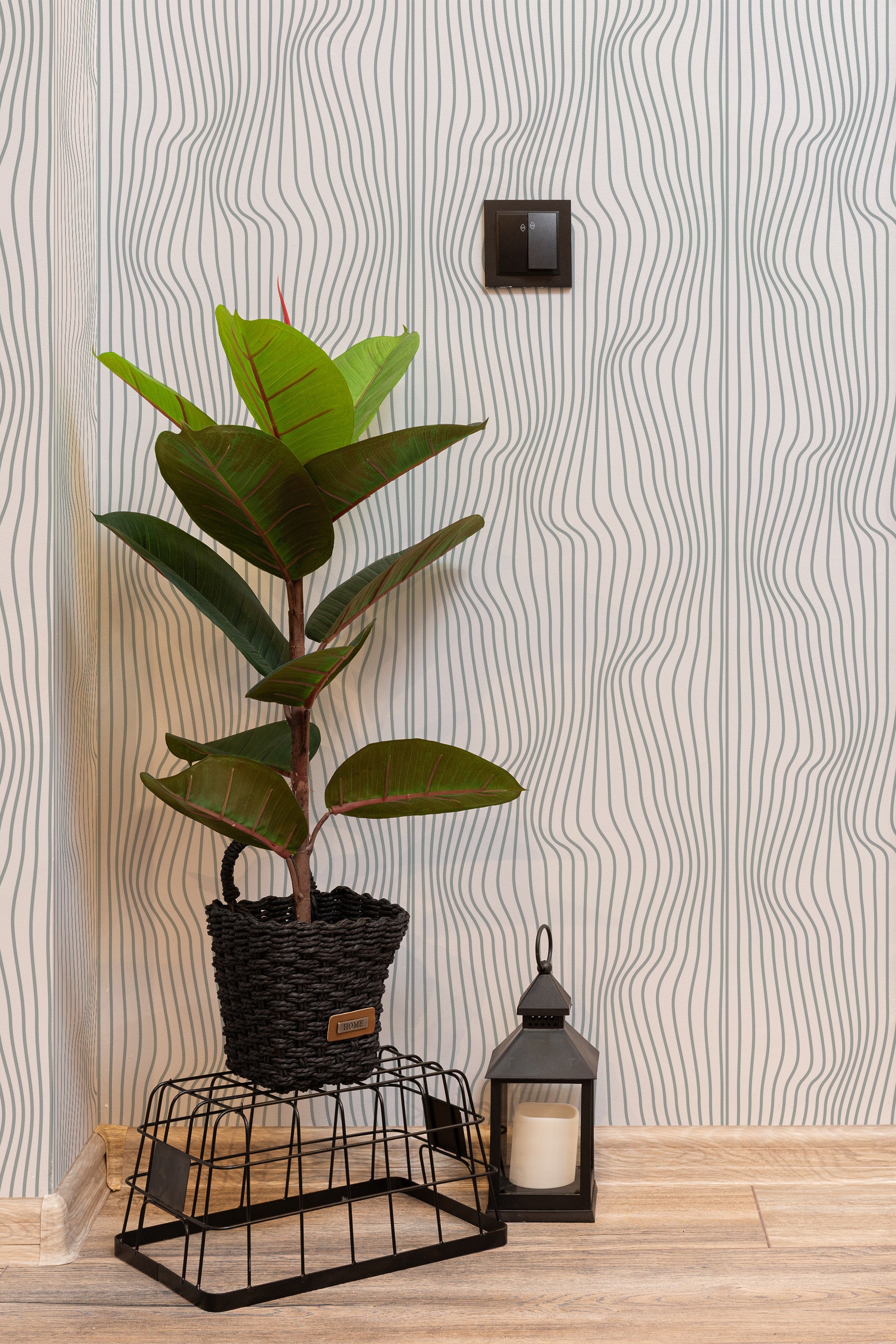 Self-adhesive wallpaper with a black and white illusion line art design of wavy vertical lines.