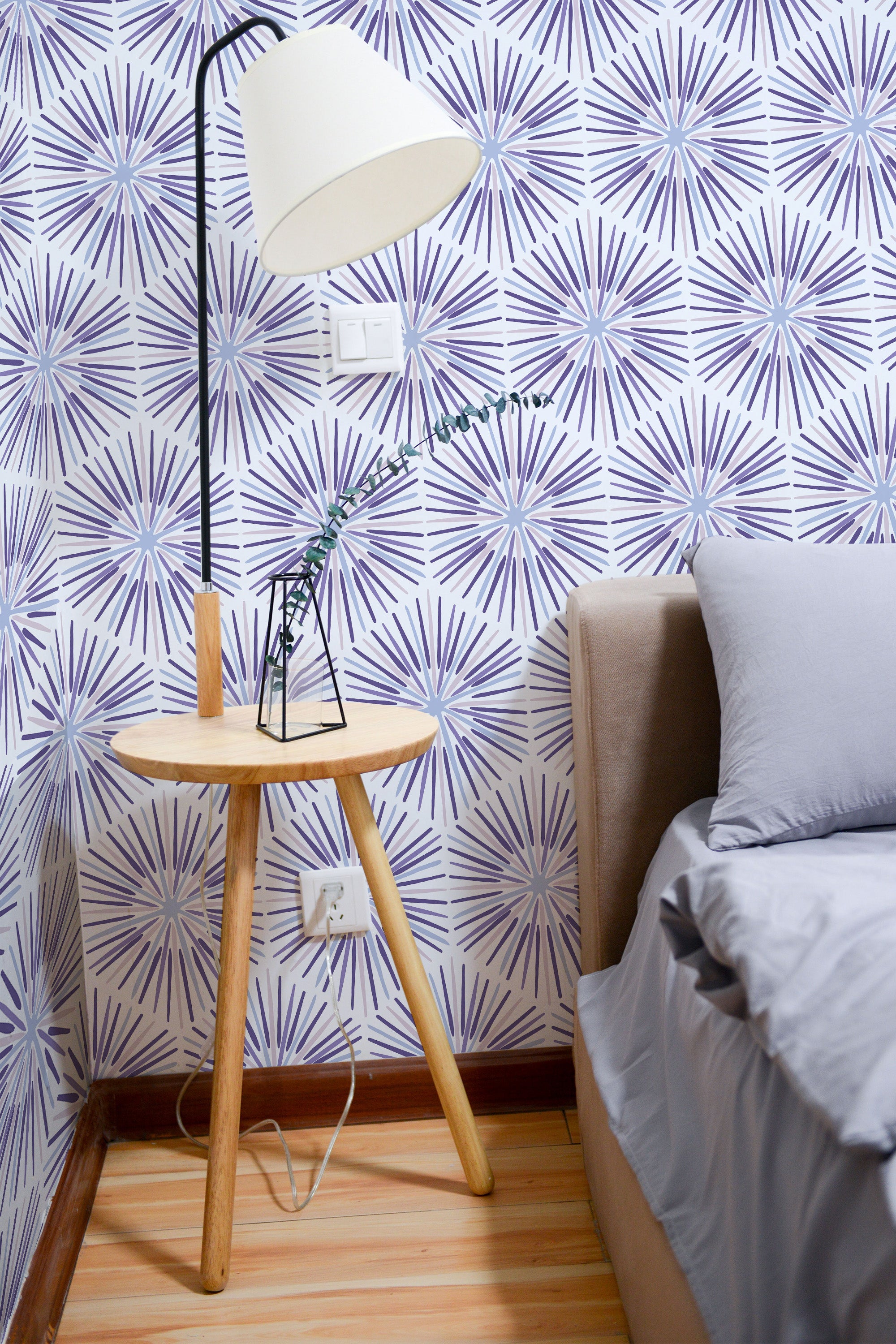 Self-adhesive purple star tile wallpaper with a geometric pattern of starburst shapes in varying shades of purple on a white background, creating a bold, modern aesthetic.
